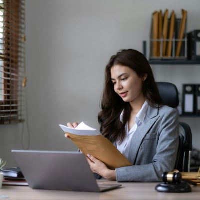 Asian lawyer woman working with a laptop computer in a law office. Legal and legal service concept.